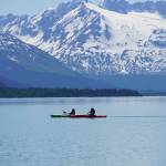 Kayakers paddle across Kenai Lake on Saturday, June 12, 2021, near Seward, Alaska. (Photo by Michael Armstrong/Homer News)
