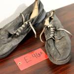 A pair of shoes recovered from the 1952 crash of a C-124 Globemaster were found this month on Colony Glacier and displayed at Joint Base Elmendorf-Richardson, Alaska, Tuesday, Sept. 29, 2021. The plane slammed into a mountain, killing 52 on board, and the plane and its crew have since become part of the glacier. The military has conducted annual summer recovery efforts, finding human remains and personal items on the glacier. (AP Photo/Mark Thiessen)