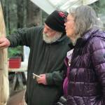 Sara Berg, right, talks with artist Brad Hughes, left, at Hughes Homer, Alaska, studio in June 2021 about the Loved & Lost Memorial Bench project Berg and other family and friends of Anesha Murnane commissioned to honor Murnane and other missing woman and children. (Photo by Christina Whiting)
