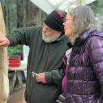 Sara Berg, right, talks with artist Brad Hughes, left, at Hughes Homer, Alaska, studio in June 2021 about the Loved & Lost Memorial Bench project Berg and other family and friends of Anesha Murnane commissioned to honor Murnane and other missing woman and children. (Photo by Christina Whiting)