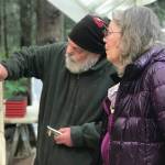 Sara Berg, right, talks with artist Brad Hughes, left, at Hughes' Homer, Alaska, studio in June 2021 about the Loved & Lost Memorial Bench project Berg and other family and friends of Anesha Murnane commissioned to honor Murnane and other missing woman and children. (Photo by Christina Whiting)