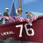 Dave Collette-Paule, left, Dave Seaman, center, and Mike Kennedy, right ready No. 76 for Homers Fourth of July Parade on Sunday, July 4, 2021, in Homer, Alaska. (Photo by McKibben Jackinsky)