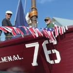 Dave Collette-Paule, left, Dave Seaman, center, and Mike Kennedy, right ready No. 76 for Homer's Fourth of July Parade on Sunday, July 4, 2021, in Homer, Alaska. (Photo by McKibben Jackinsky)