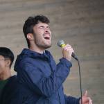 Raphie Orleck-Jetter sings a solo with the rest of the Yale University Whiffenpoofs backing him at a concert Thursday, July 8, 2021, at the Boathouse Pavillion in Homer, Alaska. The group also did a workshop Thursday at the Homer Council on the Arts. (Photo by Michael Armstrong/Homer News)
