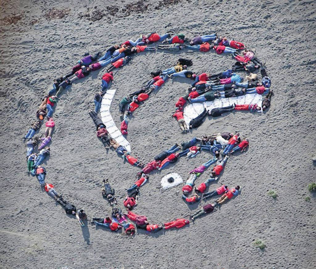 Photo Scott Dickerson and courtesy of Mavis Muller 
ShapingFuture, Mavis Mullers first human mosaic ground design action, was held on Sept. 26, 2009, on International Climate Change Action Day at Bishops Beach in Homer, Alaska.
