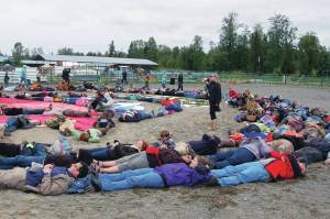 Mavis Muller, center, with bull horn, arranged Salmonfest attendees for an aerial art event in the rodeo arena at Kenai Peninsula Fairgrounds near Ninilchik, Alaska. (Photo courtesy of Mavis Muller)