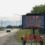 A portable sign on the Sterling Highway heading into Homer, Alaska, on Tuesday, Aug. 3, 2021, shows a COVID-19 safety alert. (Photo by Michael Armstrong/Homer News)