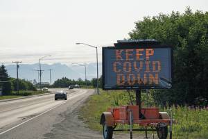 A portable sign on the Sterling Highway heading into Homer, Alaska, on Tuesday, Aug. 3, 2021, shows a COVID-19 safety alert. (Photo by Michael Armstrong/Homer News)