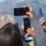 The crowd takes photos as Olympic gold medalist Lydia Jacoby passes through Seward during her celebratory parade on Thursday, August 5, 2021. (Camille Botello / Peninsula Clarion)