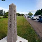 A line of vehicles wait to enter Canada at the Peace Arch border crossing Monday, Aug. 9, 2021, in Blaine, Wash. Canada lifted its prohibition on Americans crossing the border to shop, vacation or visit, but America kept similar restrictions in place, part of a bumpy return to normalcy from coronavirus travel bans. (AP Photo/Elaine Thompson)