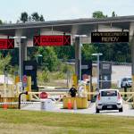 FILE - In this June 8, 2021, file photo, a car approaches one of the few lanes open at the Peace Arch border crossing into the U.S. in Blaine, Wash. Canada is lifting its prohibition Monday, Aug. 9 on Americans crossing the border to shop, vacation or visit, but the United States is keeping similar restrictions in place for Canadians. The reopening is part of a bumpy return to normalcy from COVID-19 travel bans.  (AP Photo/Elaine Thompson, File)