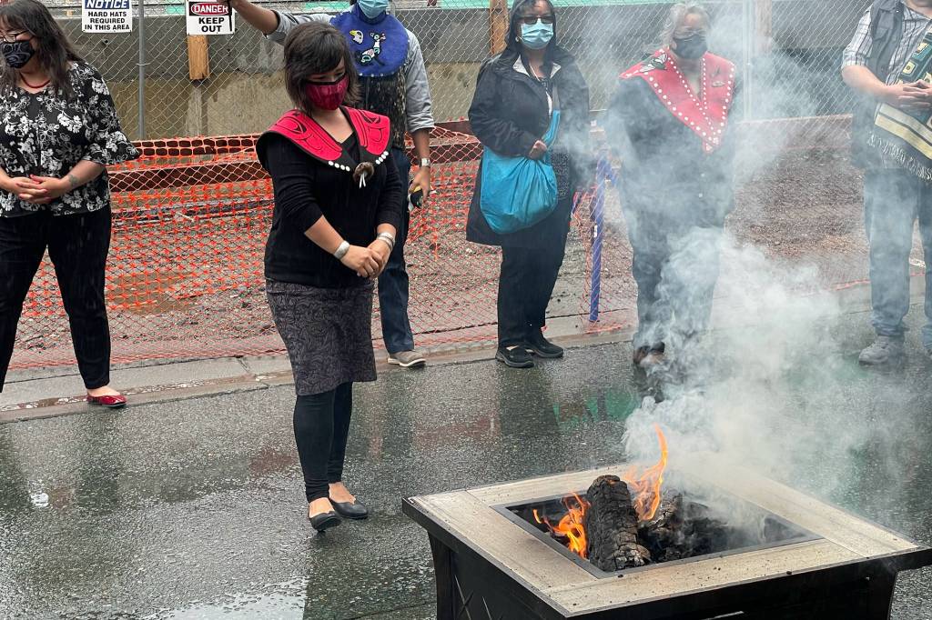 Michael S. Lockett / Juneau Empire
Lily Hope, daughter of famed artist and weaver Clarissa Rizal, watches the burning of a commercial garment at the center of a ceremony commemorating the settlement in an intellectual property lawsuit against a fashion company on Friday, Aug. 13, 2021.