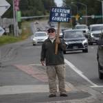 Kevin Hall stands at the Y intersection of the Kenai Spur and Sterling highways in Soldotna on Saturday, Aug. 14 to protest mandatory COVID-19 vaccines and mitigation protocols. (Camille Botello/Peninsula Clarion)
