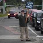 Kevin Hall stands at the Y intersection of the Kenai Spur and Sterling highways in Soldotna on Saturday, Aug. 14 to protest mandatory COVID-19 vaccines and mitigation protocols. (Camille Botello/Peninsula Clarion)