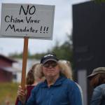 A demonstrator stands at the Y intersection of the Kenai Spur and Sterling highways in Soldotna on Saturday, Aug. 14 to protest mandatory COVID-19 vaccines and mitigation protocols. (Camille Botello/Peninsula Clarion)