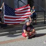 Marine Corps and Army veteran Darren Hafford talks to watchers in front of the Alaska State Capitol before beginning a push-up set as part of a fundraising effort where Hafford is traveling to every state capitol building and doing pushups in front of them to raise awareness and money for veteran suicide prevention. Juneau is his 49th, with only Hawaii remaining. (Michael S. Lockett / Juneau Empire)