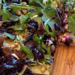 Arugula, pine nuts, and the blueberry relish top meats and homemade pizza dough. (Photo by Tress Dale/Peninsula Clarion)