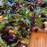 Arugula, pine nuts, and the blueberry relish top meats and homemade pizza dough. (Photo by Tress Dale/Peninsula Clarion)