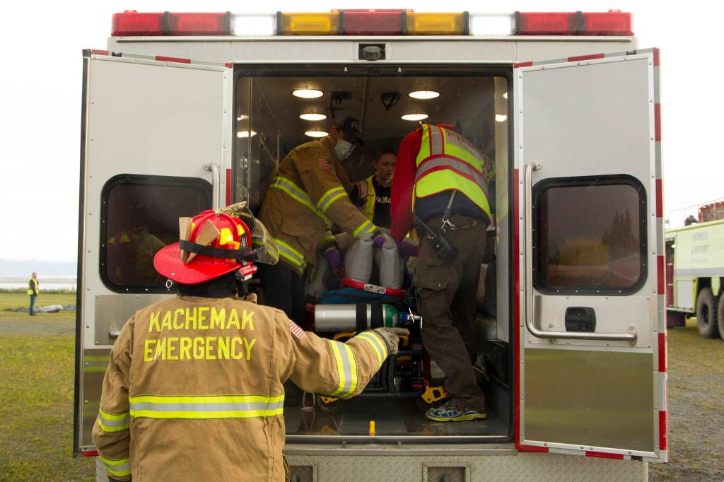 EMTs assess a plane crash victims wounds before transporting them to a medical facility. (Photo by Sarah Knapp/Homer News)