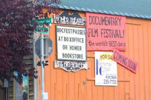 A sign advertising the annual Homer Documentary Film Festival hangs on the side of the Homer Theatre Wednesday, Sept. 19, 2018 in Homer, Alaska. (Photo by Megan Pacer/Homer News)