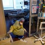 An ICU nurse, moves electrical cords for medical machines, outside the room of a patient suffering from COVID-19, in an intensive care unit at the Willis-Knighton Medical Center in Shreveport, La. The COVID-19 pandemic has created a nurse staffing crisis that is forcing many U.S. hospitals to pay top dollar to get the help they need to handle the crush of patients this summer. (AP Photo/  Gerald Herbert)