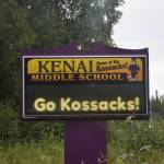 A sign in front of Kenai Middle School is seen on Sept. 2, 2021, in Kenai, Alaska. The school was one of more than a dozen Kenai Peninsula Borough School District schools operating with universal indoor masking due to rising COVID-19 cases. (Photo by Jeff Helminiak/Peninsula Clarion)