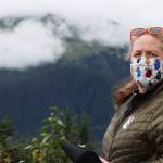 Elizabeth Graham, entomologist for the U.S. Forest Service, talks about the black-headed budworm outbreak in front of a spot on Mount McGinnis that shows the effects of defoliation. (Ben Hohenstatt / Juneau Empire)