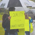 \Camille Botello/Peninsula Clarion
Protesters stand outside the George A. Navarre Borough Admin building in Soldotna on Tuesday.
