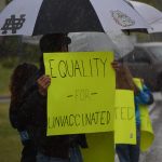 Protesters stand outside the George A. Navarre Borough Admin building in Soldotna on Tuesday, Sept. 14, 2021. (Camille Botello/Peninsula Clarion)