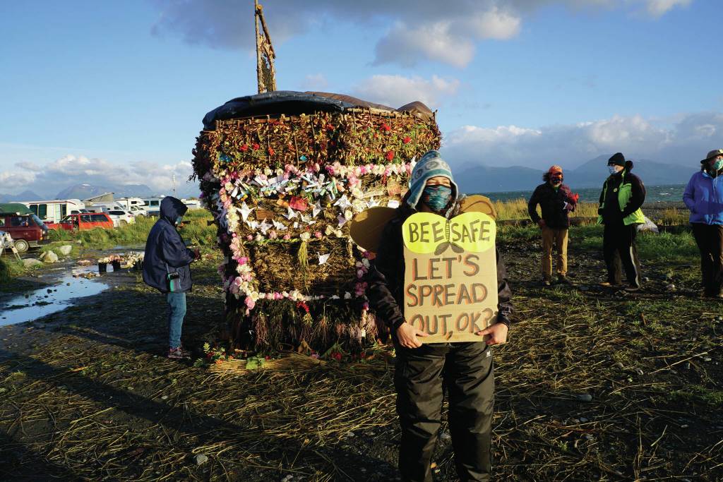 A person in a bee constume encourages people to spread out at Recover, the 18th annual Burning Basket, before it burns on Sunday, Sept. 12, 2021, at Mariner Park on the Homer Spit in Homer, Alaska. (Photo by Michael Armstrong/Homer News)