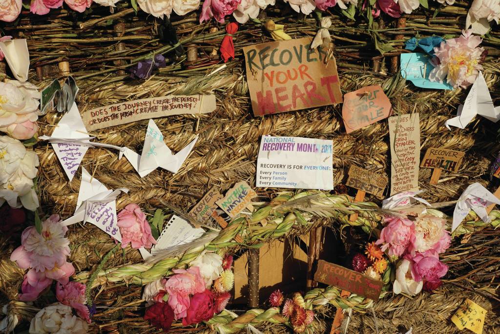 Signs, flowers and origami cranes decorate Recover, the 18th annual Burning Basket, on Sunday, Sept. 12, 2021, at Mariner Park on the Homer Spit in Homer, Alaska. The baskets theme also coincided with National Recovery Month for September. (Photo by Michael Armstrong/Homer News)