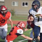 Homer quarterback Carter Tennison tries to avoid the tackle of Kenai Centrals Talon Whicker on Friday, Sept. 17, 2021, at Ed Hollier Field in Kenai, Alaska. (Photo by Jeff Helminiak/Peninsula Clarion)