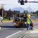 Workers on Tuesday, Sept. 21, 2021, paint the fog or right side lane lineon the Homer Bypass at Lake Street as reconstruction winds down for the summer inHomer, Alaska. (Photo by Michael Armstrong/Homer News)