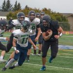 Mariner football player Carter Tennison carries the ball down the field against the Redington Huskies. (Photo by Sarah Knapp/Homer News)