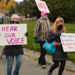 Demonstrators are seen marching down Pioneer Avenue to WKFL Park holding signs demanding womens rights. (Photo by Sarah Knapp/Homer News)