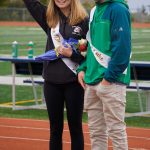 Sophomore class Duchess Minadora Reutov adjusts her crown as Duke Camden Wise watches at the Homer vs. Nikiski junior varsity football game on Saturday, Oct. 2, 2021, at Homer High School. (Photo by Michael Armstrong/Homer News)