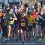 Author Kathleen Sorensen (252) and the rest of the field take off from the starting line at the Kenai River Marathon on Sunday, Sept. 26, 2021, in Kenai, Alaska. (Photo by Jeff Helminiak/Peninsula Clarion)