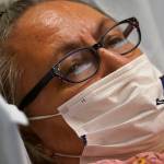 Joyce Johnson-Albert looks on as she receives an antibody infusion while lying on a bed in a trauma room at the Upper Tanana Health Center Wednesday, Sept. 22, 2021, in Tok, Alaska. Johnson-Albert was optimistic but also realistic. "I just hope the next few days I'll be getting a little better than now," Johnson-Albert told a reporter on the other side of a closed, sliding glass door to the treatment room two days after testing positive for COVID-19 and while receiving an antibody infusion. "It's just hard to say. You can go either way." (AP Photo / Rick Bowmer)