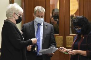 From left to right: Speaker of the Alaska House of Representatives Louise Stutes, R-Kodiak, House Majority Leader Chris Tuck, D-Anchorage, and House Minority Leader Cathy Tilton, R-Wasilla, discuss messages from the Senate in the hall of the Alaska State Capitol on Monday, Oct. 4, 2021. A plan to hold the special session mostly from afar was hampered by demands from Republican Senators. (Peter Segall / Juneau Empire)