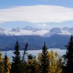 Golden-yellow birch trees and spruce frame a view of Aurora Lagoon and Portlock Glacier from a trail in the Cottonwood-Eastland Unit of Kachemak Bay State Park off East End Road on Sunday, Oct. 3, 2021, near Homer, Alaska. (Photo by Michael Armstrong)