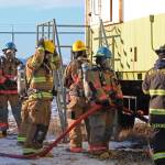 Firefighters from multiple agencies prepare to enter a structure with a fire burning inside it as part of a live fire exercise Saturday, Feb. 23, 2019 at the Homer Volunteer Fire Departments fire training facility on Freight Dock Road in Homer, Alaska. Student volunteers from Anchor Point Emergency Services, Homer Volunteer Fire Department, Ninilchik Emergency Services, and Central Emergency Services attended the drill as part of a joint Firefighter I class they are attending hosted by Anchor Point Fire and HVFD. (Photo by Megan Pacer/Homer News)