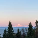 The sunrise shines on Mt. Redoubt Sunday, Oct. 10, creating hues of pinks, yellows and blues as it lights up the sky. (Photo by Sarah Knapp/Homer News)