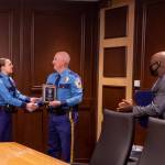 Department of Public Safety Commissioner James Cockrell (center) presents Wildlife Trooper Laura Reid (left) with a Life-Saving Award for her efforts in rescuing a child from the Kenai River offshore of North Kenai Beach this summer, during a ceremony held by Gov. Mike Dunleavy on Oct. 13, 2021. Reid and Kenai River dipnetter Antoine Aridou (far right) rescued the 12-year-old on July 29, 2021. (Photo provided by the Office of the Governor)