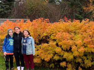 The grands  Luca, Cecilia and Flora  pause on a fall garden walk. (Photo by Rosemary Fitzpatrick)