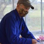 Charles Maier fills goodie bags at the Kenai Senior Center on Friday, Oct. 22, 2021 for next weekends drive-through trick-or-treat event. (Camille Botello/Peninsula Clarion)