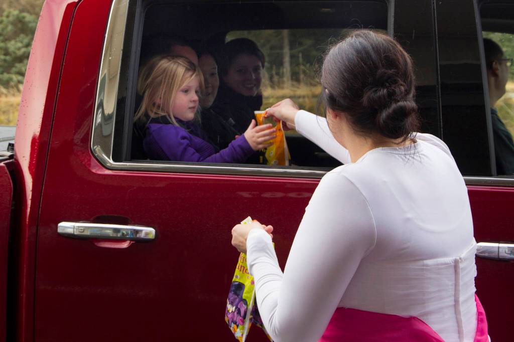Homer Thrift employees pass out candy during the Haven House Halloween drive-thru Sunday, Oct. 31. (Photo by Sarah Knapp/Homer News)