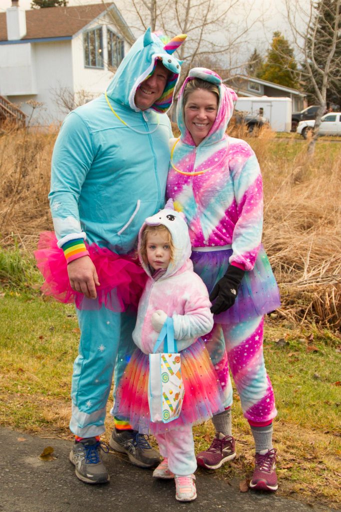 Jake, Krista and Isley Parrett take on trick-or-treating on Bayview Avenue as a family of unicorns. (Photo by Sarah Knapp/Homer News)