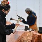 University of Alaska Student Skaydu.û Jules, carves a red cedar log under the supervision of Tlingit master carver Wayne Price in the parking lot of Angoon High School on Tuesday. Jules, a member of the Teslin Tlingit Council, a self-governing First Nation based in Teslin in Southern Yukon Territory, Canada, and said she wants to become a Tlingit language teacher.