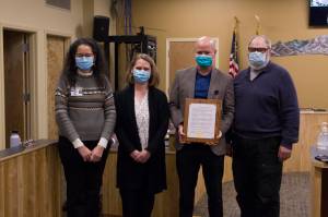 Derotha Ferraro, Dr. Christy Tuomi, Ryan Smith and Ken Castner pose for a photo with South Peninsula Hospitals mayoral recognition plaque. (Photo by Sarah Knapp/Homer News)