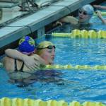 Sewards Lydia Jacoby hugs Jean Cook after she wins her race during the state swimming finals at Bartlett High School in Anchorage on Saturday, Nov. 6, 2021. (Camille Botello/Peninsula Clarion)